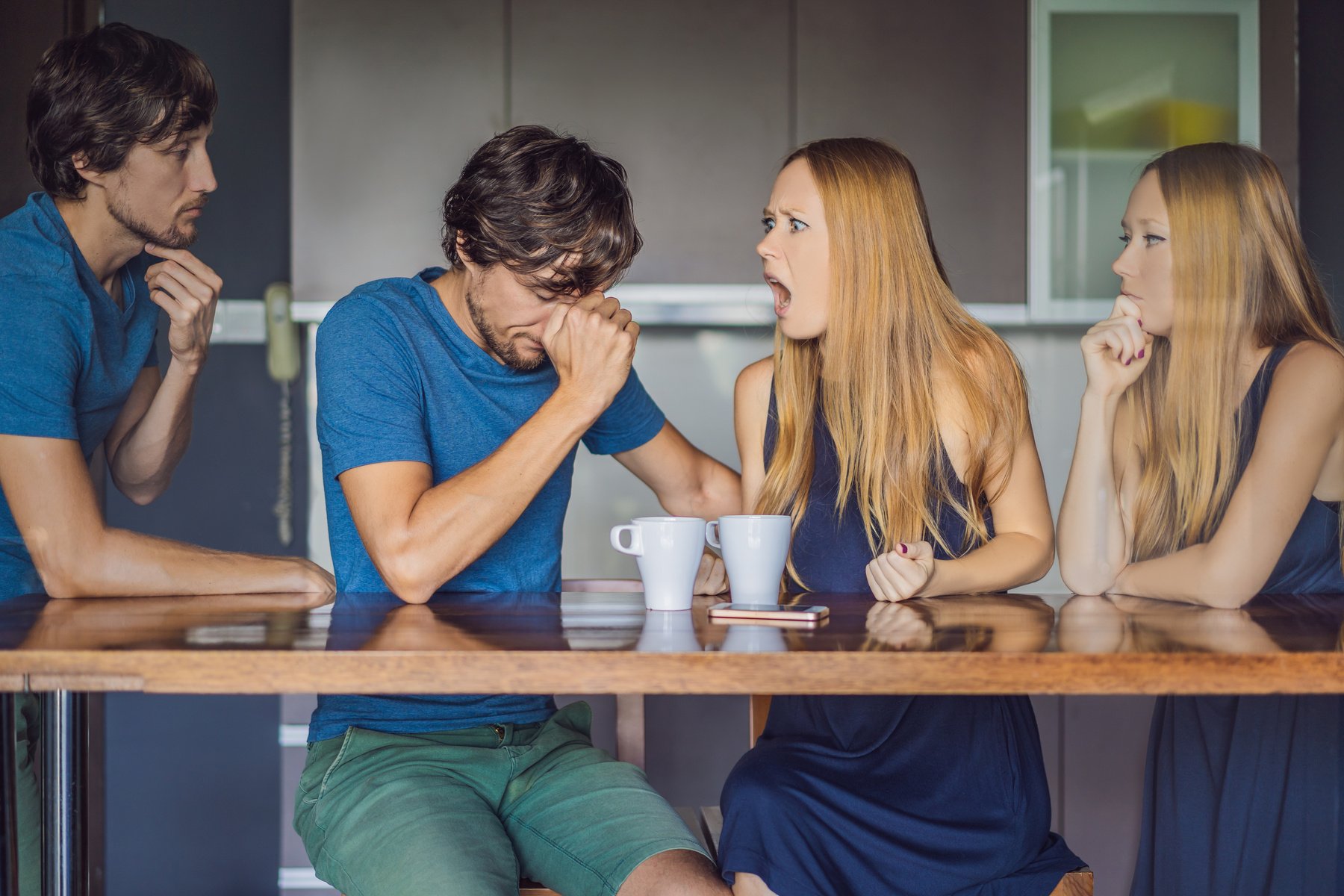 Young couple swears in the kitchen. Watch and evaluate their behavior from the side. Emotional intelligence concept